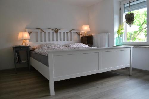 a white bed in a room with a window at Feriendomizil "Anker" H 2 in Trent