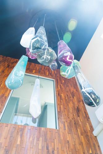 a group of glass lights hanging from a ceiling at The Saint Hotel in St Pete Beach