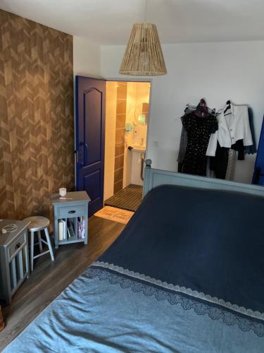 1 dormitorio con cama azul y baño en Galloyer House, en Mulsanne