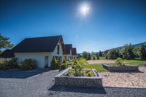 a house with two planters in front of it at Domki Platan w Karkonoszach in Kowary