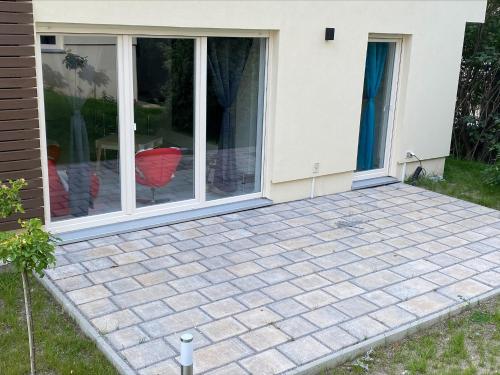 a patio in front of a house with sliding glass doors at Designpension Idyll Nr21 Hotel Garni in Wernigerode