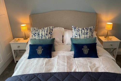 a bedroom with a bed with blue and white pillows at Mayfield Apartment Luxury first floor 1 bedroom apartment in Great Eccleston