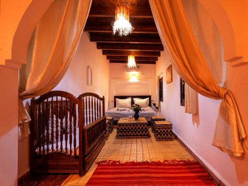 a hallway with a room with two beds and a couch at Riad ViewPoint in Marrakesh