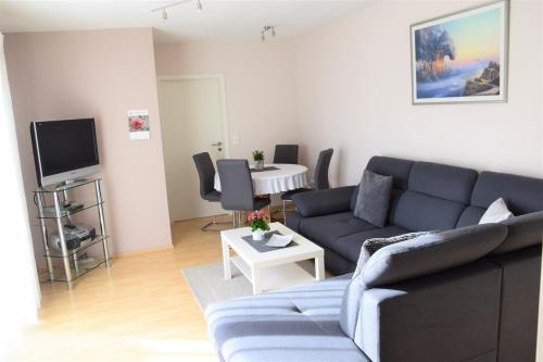 a living room with a couch and a table at Ferienwohnung Borken in Bad Salzungen