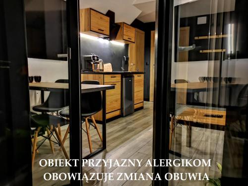 a kitchen with a table and chairs in a room at Widokowy Szczawnica in Szczawnica