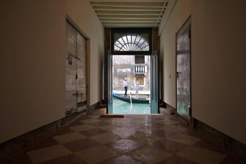 an empty hallway with an open door to a canal at CA FOSCARINI 1 in Venice