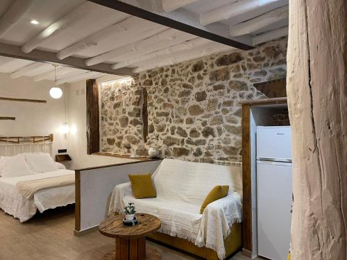 a room with two beds and a refrigerator in it at Apartamento La Herrerita in Candelario
