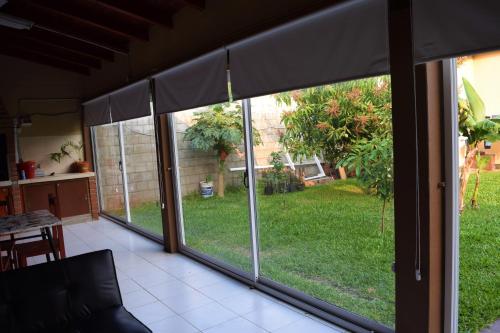 a screened in porch with a view of a yard at Apart Iberá in Ituzaingó