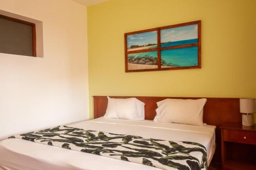 a bedroom with a bed and two windows at Misturod - Holiday Apartments in Santa Maria