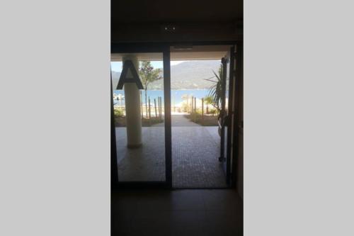an open door of a building with a view of the ocean at Appartement T2 terrasse vue mer à 180 in Propriano