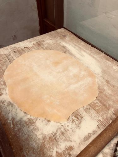 a piece of pizza dough sitting on top of a table at Al Podere del Nonno Romolo in Sansepolcro