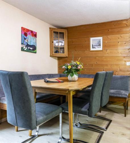 a dining room with a wooden table and chairs at Haus Ruepp in Silbertal