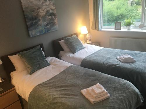 two beds sitting next to each other in a bedroom at Pennine View - Manchester: Rochdale Littleborough in Littleborough