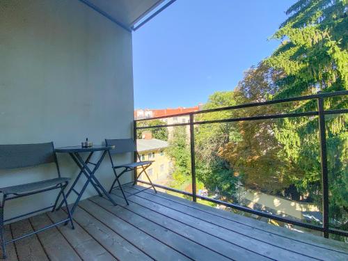 a balcony with a bench and a large window at Blackhome Graz I contactless check-in in Graz