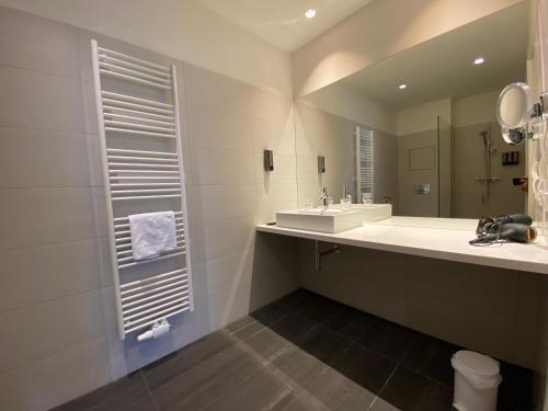 a bathroom with a sink and a mirror at Blackhome Graz I contactless check-in in Graz