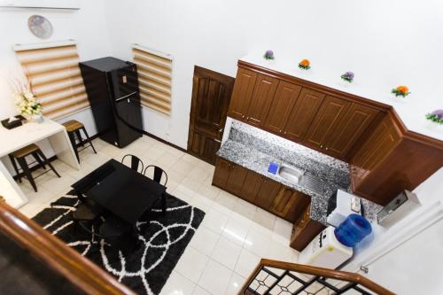 an overhead view of a kitchen with a table and chairs at Bella Casa (3BR House at Azienda Genova) in Talisay