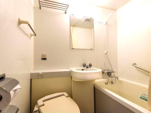 a bathroom with a sink and a toilet and a mirror at APA Hotel Akasaka-Mitsuke in Tokyo