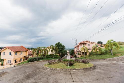 an empty street in a town with palm trees at Bella Casa (3BR House at Azienda Genova) in Talisay