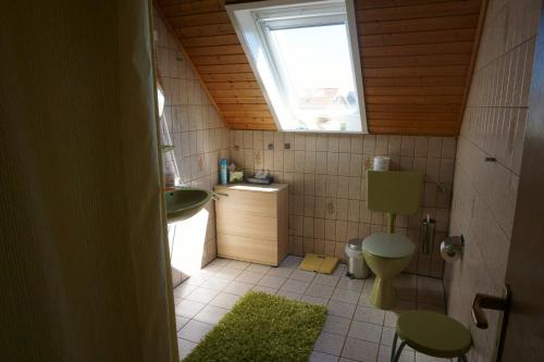 ein Bad mit einem Waschbecken, einem WC und einem Fenster in der Unterkunft Carpe Diem II 1322 in Fehmarn