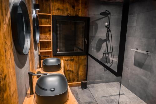 a bathroom with two stools and a mirror in a room at L'ilet aux 2 étangs in Saint-Nabord