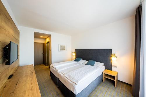 Postel nebo postele na pokoji v ubytování Hotel SKI