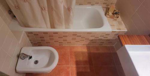 a bathroom with a bath tub and a sink at sanluis in Daimuz
