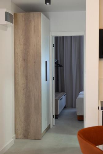 a room with a sliding door and a bedroom at 9 apartments in Jagodina