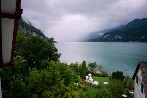 a view of a large body of water with mountains at Flyhof in Weesen