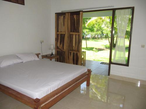 Un pat sau paturi într-o cameră la Pondok Siola