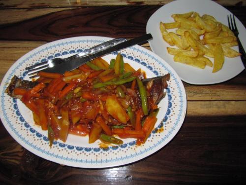 a plate of food with carrots and french fries at Pondok Siola in Labuhan Pandan