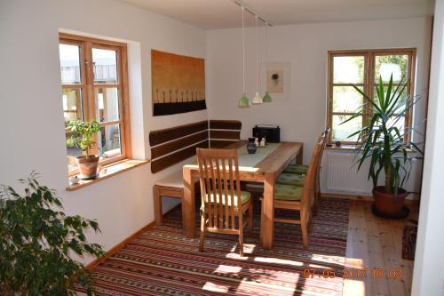 a dining room with a wooden table and chairs at "Lütt Huus" in Ostermarkelsdorf