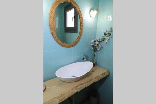 a bathroom with a white sink and a mirror at Casa Rural Alegría de Toledo, Guadamur,Puy du Fou in Guadamur