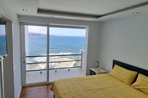 1 dormitorio con cama y vistas al océano en AguaMarina, en Punta del Hidalgo