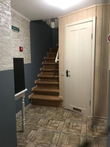 a hallway with a staircase and a white door at Budget Family Hotel in Lviv