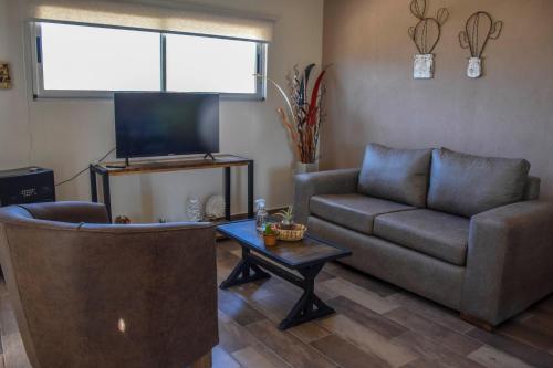 a living room with a couch and a coffee table at Potre casas de montaña in Potrerillos