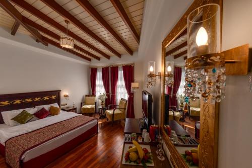 a bedroom with a bed and a large mirror at Tuvana Hotel in Antalya
