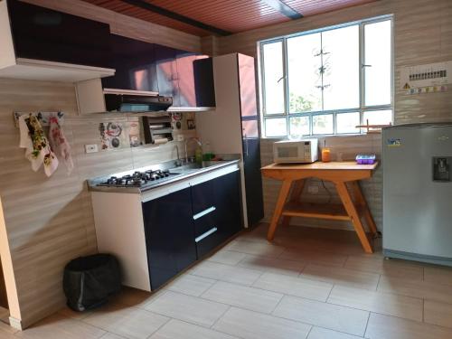 a kitchen with a stove and a table in it at Portal de la Cascada - Mongui in Monguí