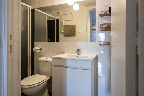 a white bathroom with a toilet and a sink at Casa de Santa Maria in Castelo de Vide