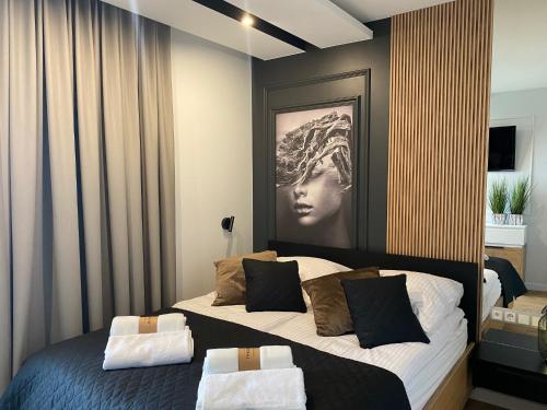 a bedroom with a bed with a picture of a woman at Family & Business Elegant Apartments Kadzielnia, ul Zgody, Stadion Korona, WDK -1 Bedroom, Terrace, Garage - NEW! in Kielce