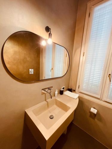 a bathroom with a sink and a mirror at Casa Citta in Brescia