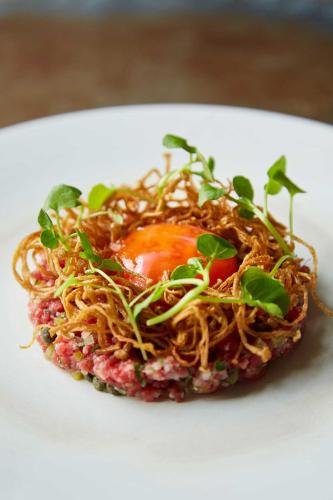 a plate of food with spaghetti and greens on it at The Beaumont Hexham in Hexham
