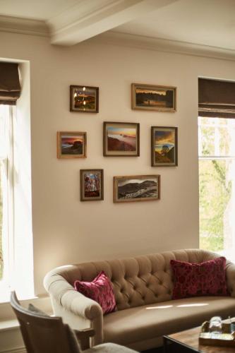 a living room with a couch and pictures on the wall at The Beaumont Hexham in Hexham