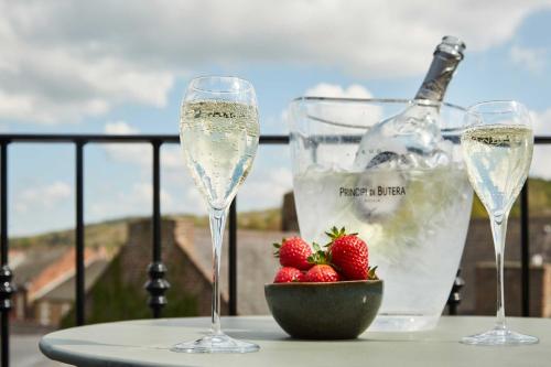 two glasses of champagne and strawberries on a table at The Beaumont Hexham in Hexham