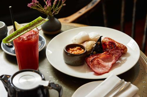 a table with a plate of food and a drink at The Beaumont Hexham in Hexham