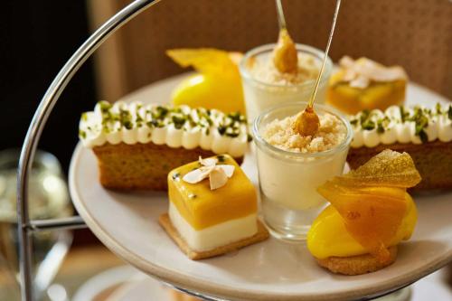 a plate of desserts on a plate with glasses of milk at The Beaumont Hexham in Hexham