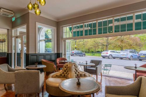 a restaurant with tables and chairs and a large window at The Beaumont Hexham in Hexham