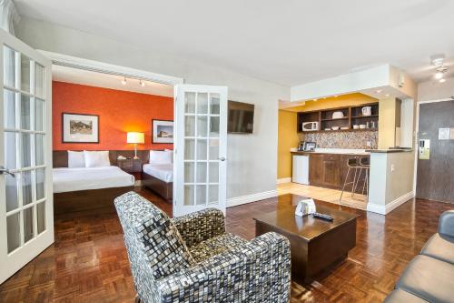 a hotel room with a bed and a living room at Town Inn Suites Hotel in Toronto
