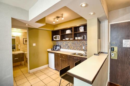 a kitchen with a sink and a counter top at Town Inn Suites Hotel in Toronto