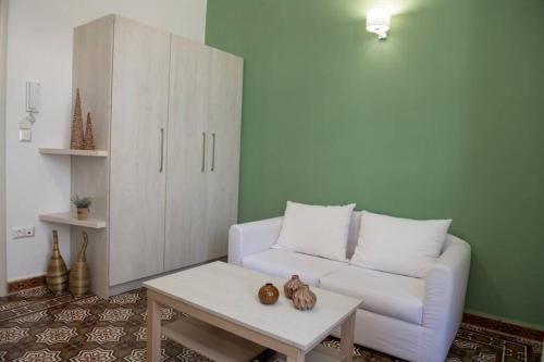 a living room with a couch and a coffee table at The Little big apartment in the heart of Heraklion in Heraklio