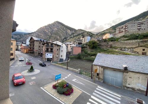 a city street with cars parked on the road at Apartament l'Areny 22- 6p - Canillo - Zona Grandvalira in Canillo
